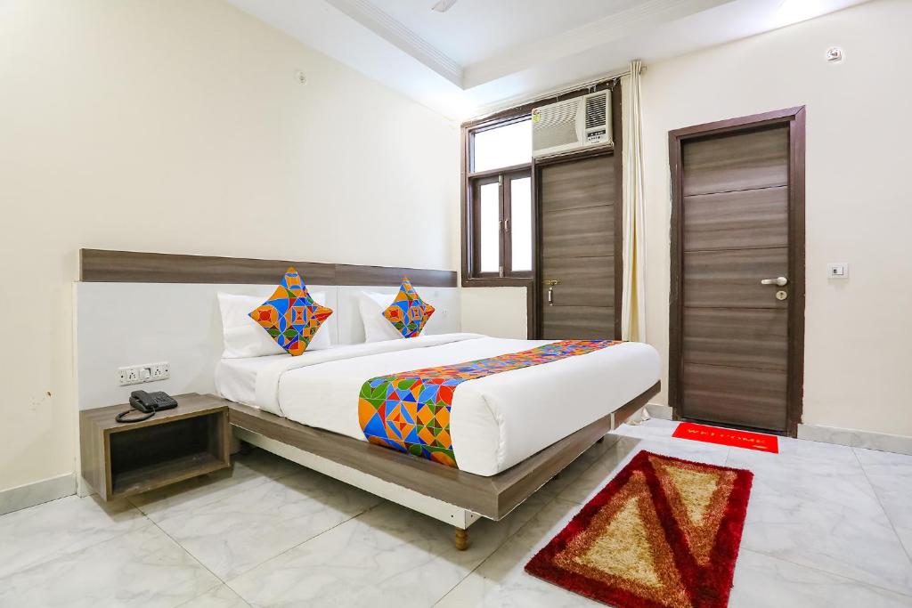 a bedroom with a large bed in a room at FabExpress Royal Orbit in New Delhi