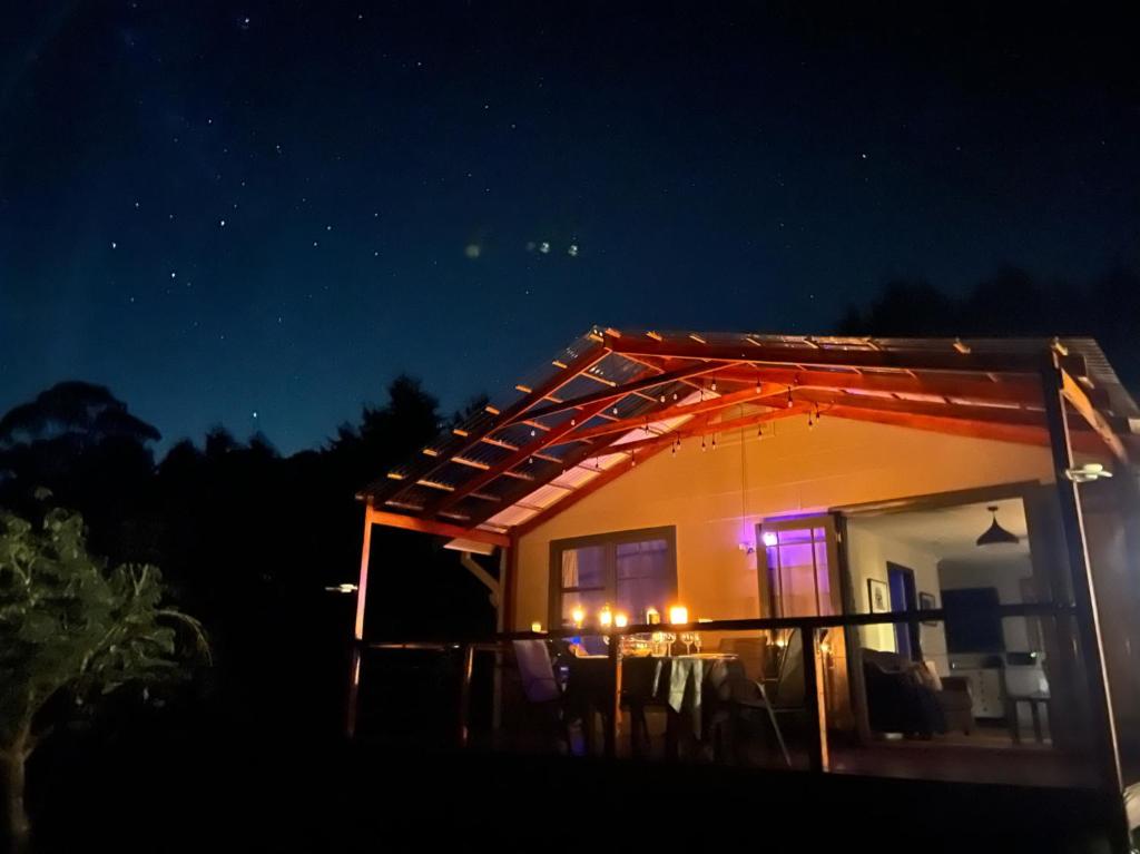 a house with a lit up roof at night at The Bower at Wildside Sanctuary in Bilpin