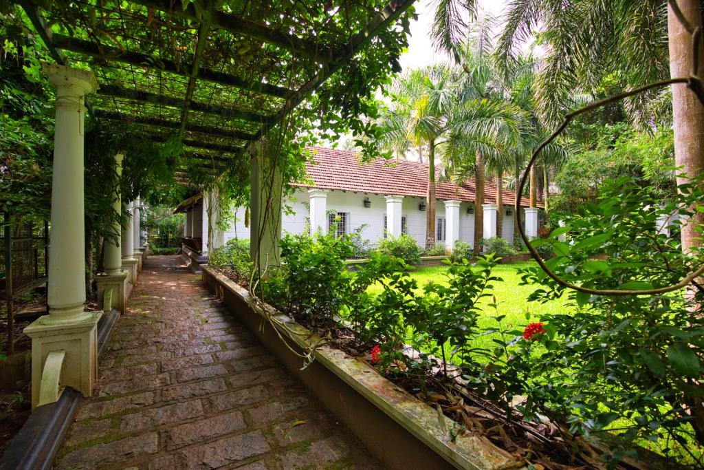 a garden with a pathway and a house at Softouch Ayurveda Village Kerala in Kizhake Chālakudi