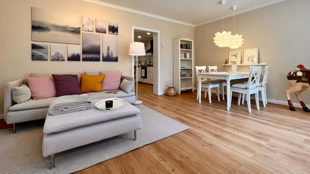 a living room with a couch and a table at "GartenTraum" - FeWo in Marienmünster - Ostwestfalen in Marienmünster