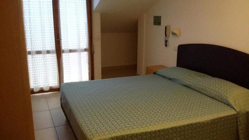 Postel nebo postele na pokoji v ubytování Hotel Matteo