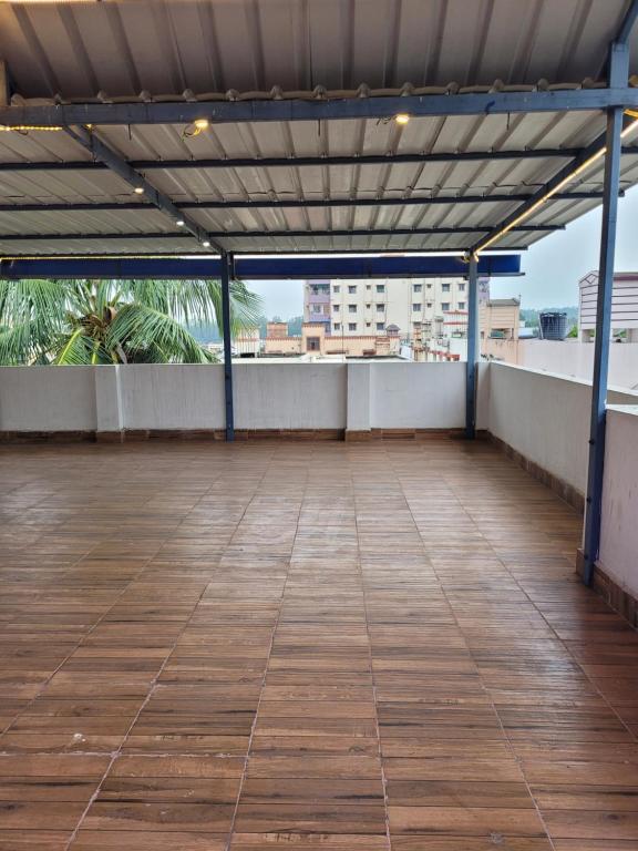 an empty rooftop patio with a view of a city at Gupta Residence. in Dhanbād