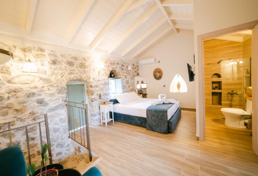 a hotel room with a bed and a bathroom at LA TORE DI MONTENEGRO in Gythio