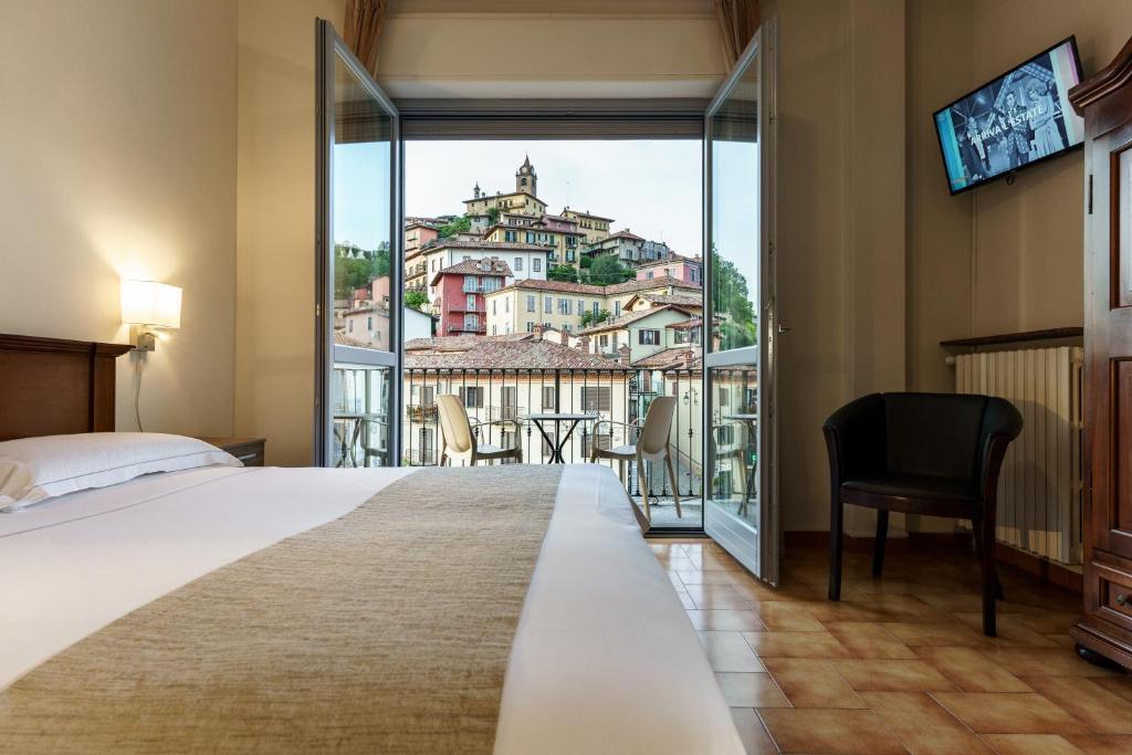 Postel nebo postele na pokoji v ubytování Hotel Il Grappolo D'Oro