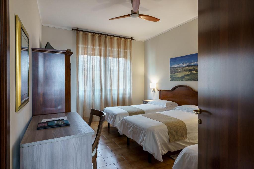 Postel nebo postele na pokoji v ubytování Hotel Il Grappolo D'Oro