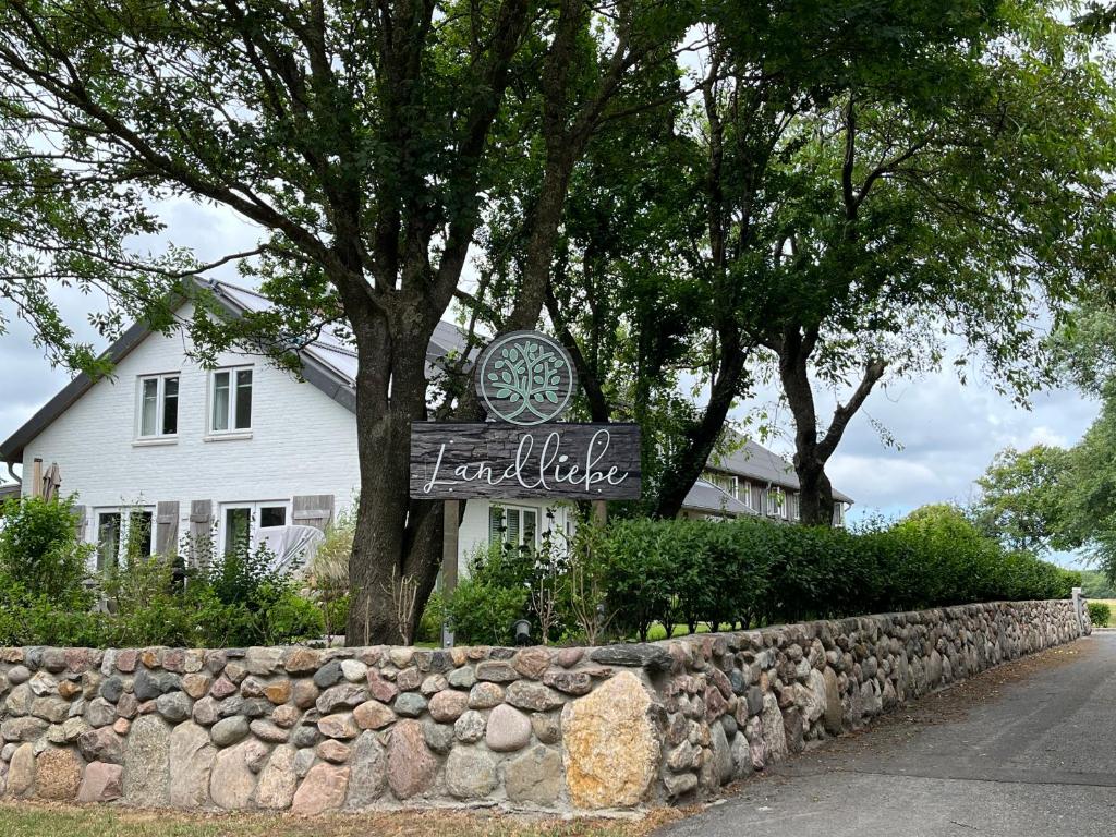 a sign in front of a white house at Landliebe in Nieblum