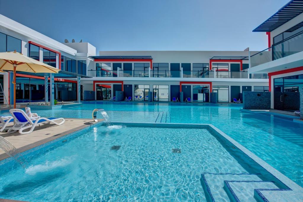 a large swimming pool in a building at KAY Homes in Ras al Khaimah