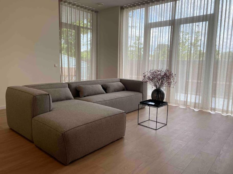 a living room with a couch and a table at New and modern apartment in the city center in Maastricht
