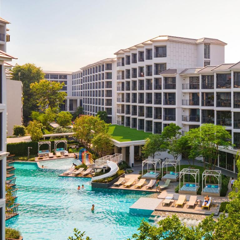 an aerial view of a pool at a resort at The Quarter Chaophraya by UHG - Riverfront Hotel, Walk to ICONSIAM in Bangkok