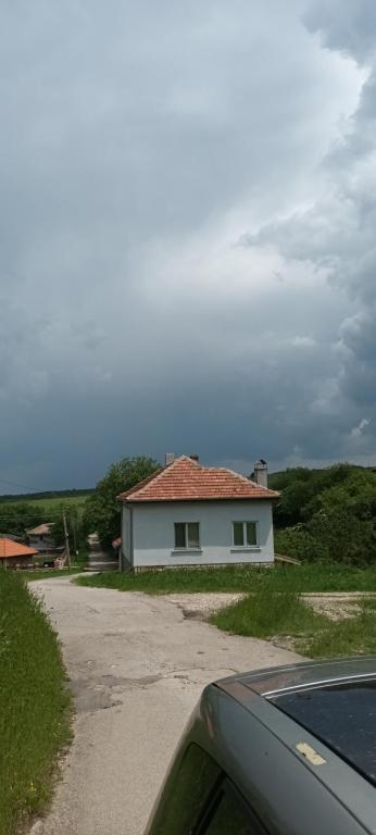 una casa blanca al lado de una carretera en ПРИ ШИВАЧА en Kŭrpachevo