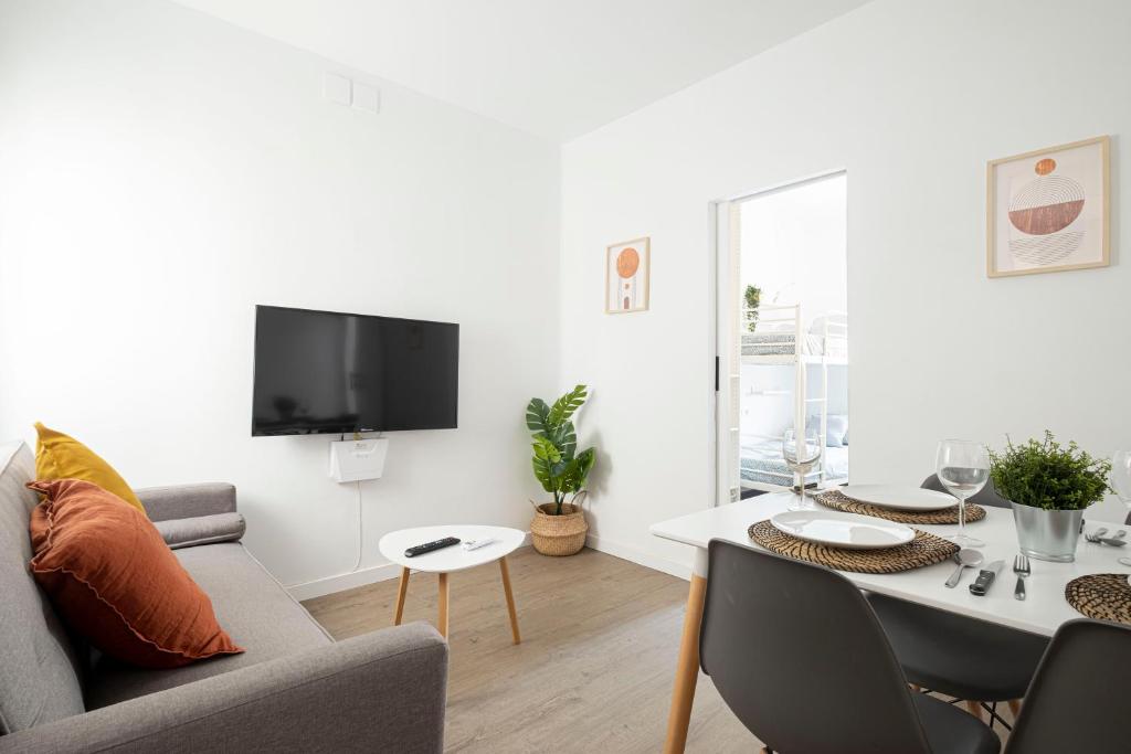 a living room with a couch and a table at APARTMENT BEACH PICASSO in Sant Adria de Besos