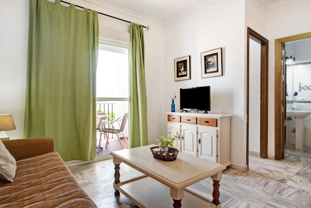 Televízia a/alebo spoločenská miestnosť v ubytovaní Apartamento Atlántico 102