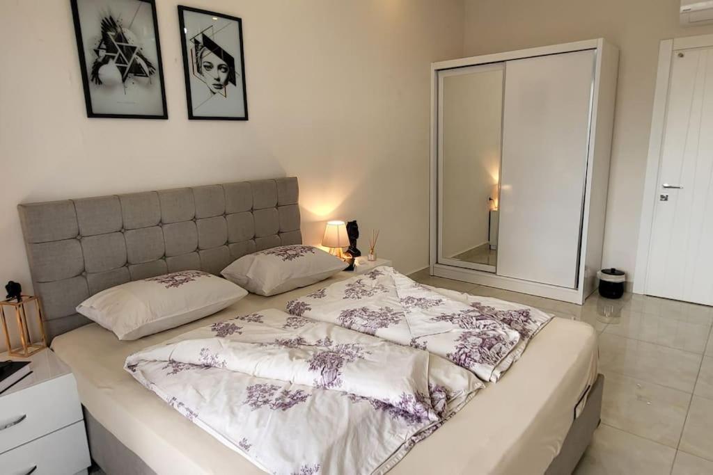 a bedroom with a large bed with two pillows at 70qm Apartment in Alanya, 2 Zimmer, Strandnähe in Alanya