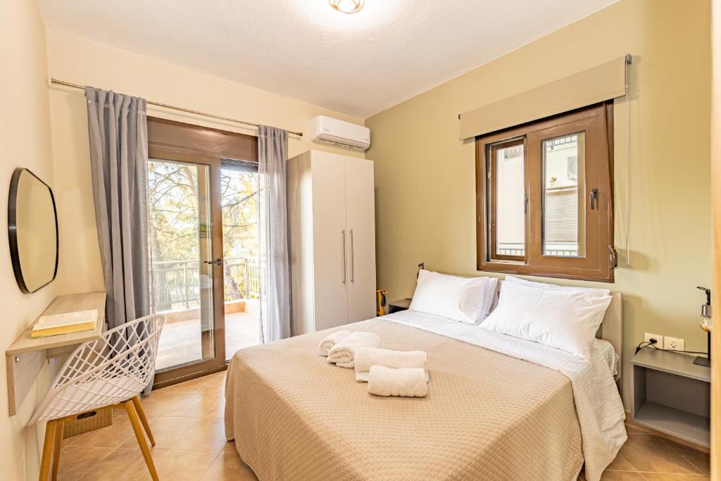 Postel nebo postele na pokoji v ubytování Natura Suites
