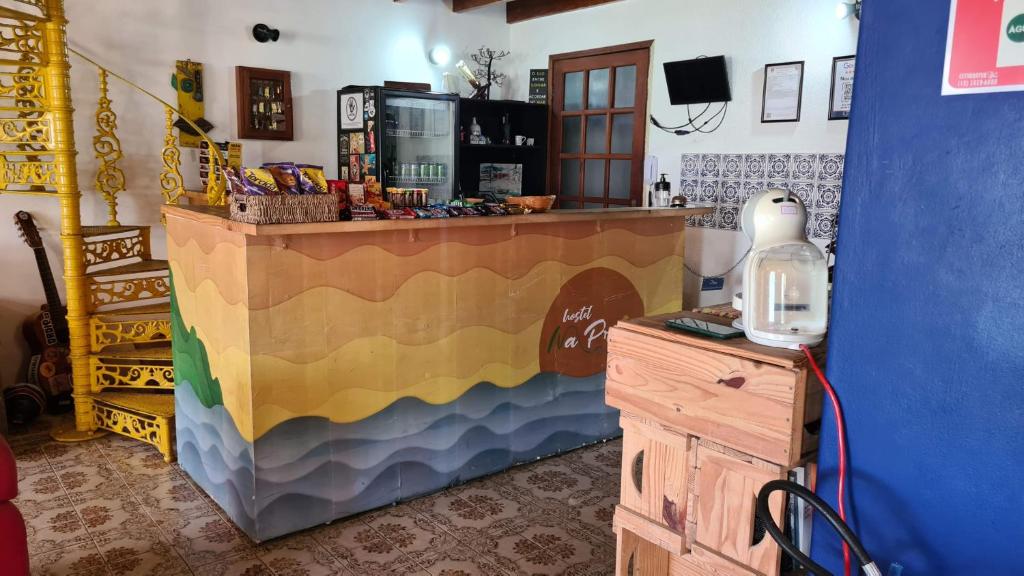 a shop with a colorful counter and a counter at Hostel Na Praia - Hospedagens e eventos in Ubatuba