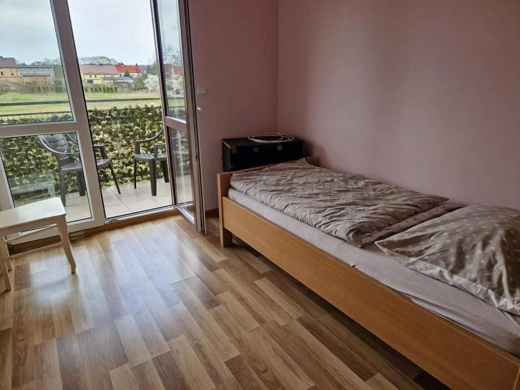 Apartament u Margherity في أنسكو: غرفة نوم بسرير ونافذة كبيرة