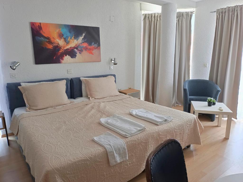 a bedroom with a bed with two towels on it at Apartments Gugoski in Ohrid