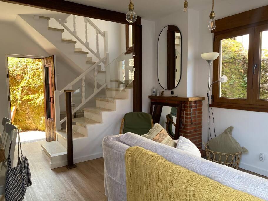 a living room with a couch and a staircase at 14A06 Casa Pepe in La Isla