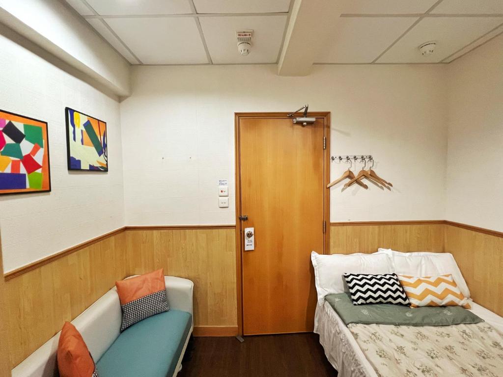 Postel nebo postele na pokoji v ubytování 利園賓館