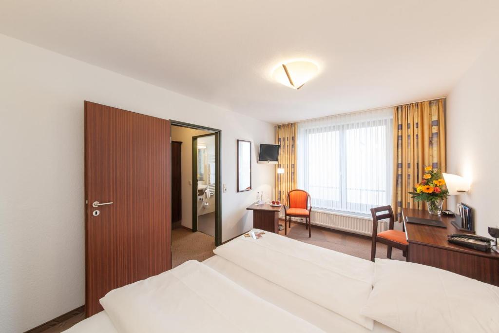 Postel nebo postele na pokoji v ubytování Hotel Strijewski