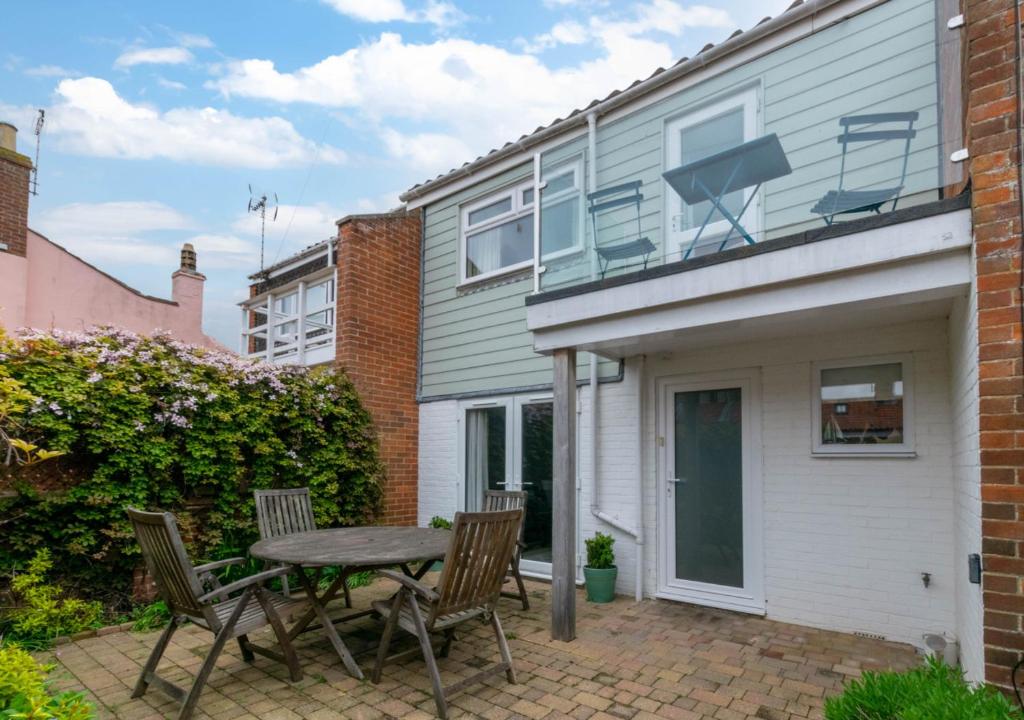 a patio with a table and chairs in front of a house at The Haven in Southwold