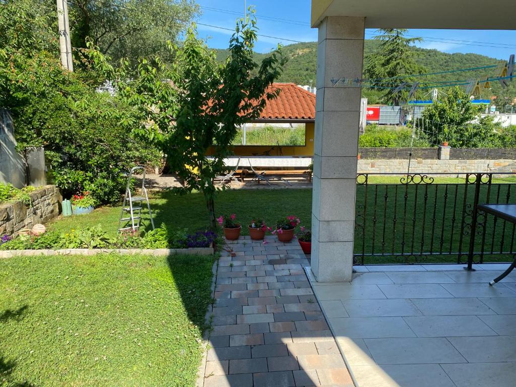 a patio with potted plants and a fence at Apartma Mira in Zgornje Škofije