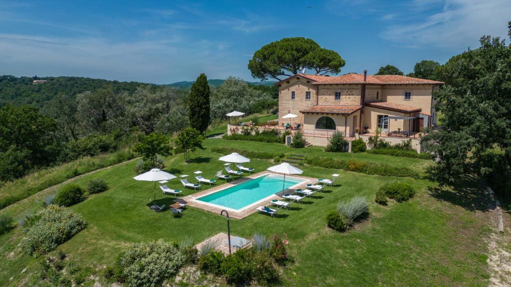an estate with a swimming pool in front of a house at Il Colle Di Donna Ilaria 16, Emma Villas in Buonconvento