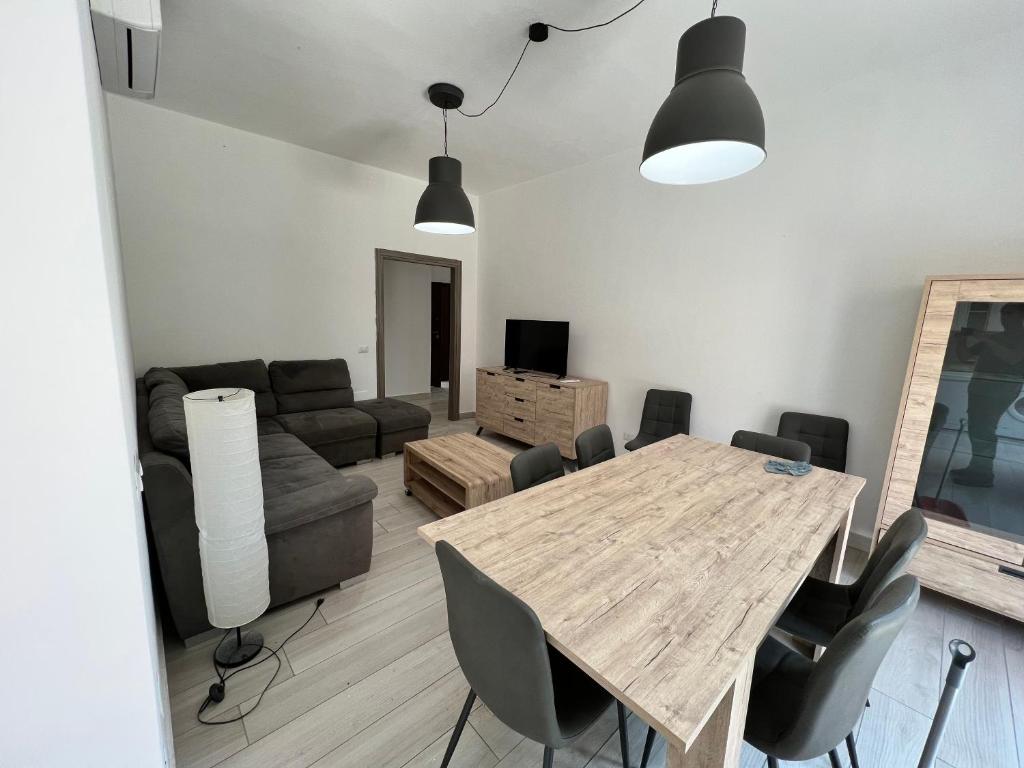 a living room with a table and a couch at I lecci in Livorno
