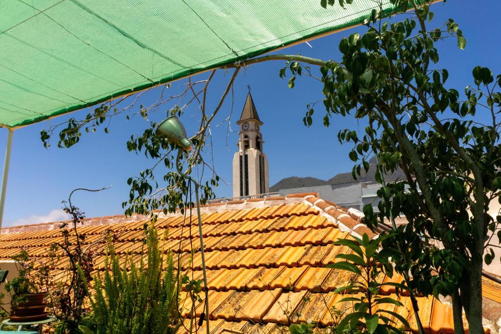 een uitzicht op een gebouw met een klokkentoren op de achtergrond bij Hostel Albergue La Casa Encantada in El Paso