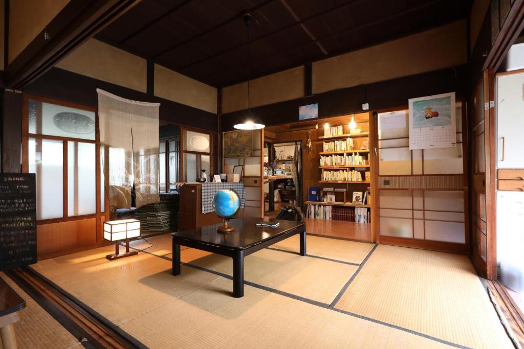 a room with a table with a globe on it at Guesthouse SETOUCHI LIFE in Kure