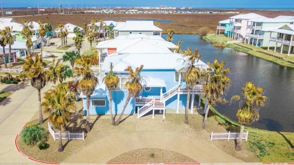 an aerial view of a house with palm trees at Villa Laguna! STEPS to the pool & lagoon views, with boardwalk to beach in Port Aransas