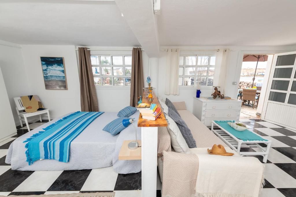 a bedroom with a bed and a table and chairs at Vista Paraiso, Sea breeze facing the sea in La Oliva