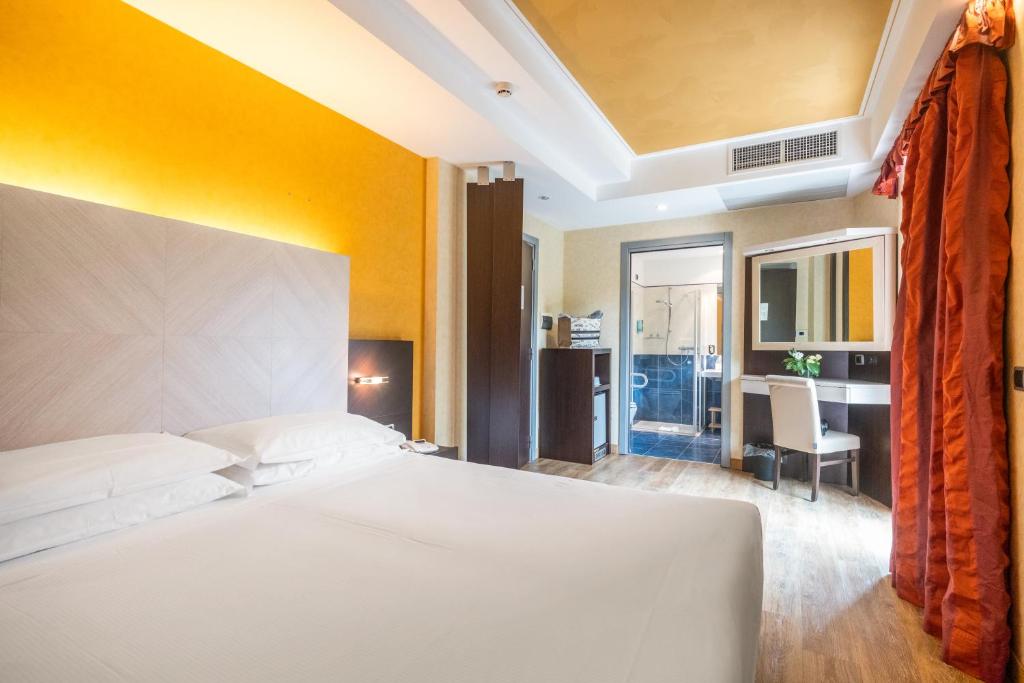 Postel nebo postele na pokoji v ubytování Kriss Internazionale Hotel