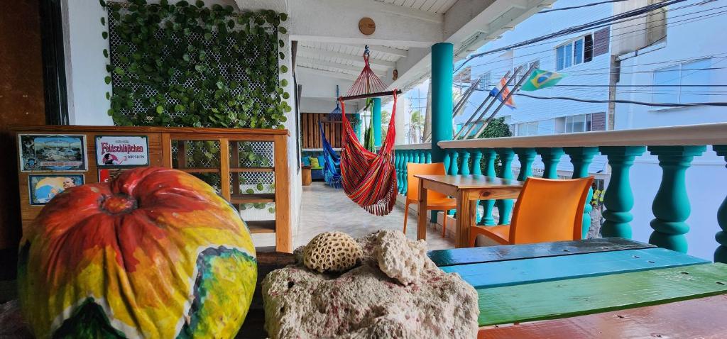 a porch with a table with a large pumpkin on it at Karibbik Haus Hostel in San Andrés