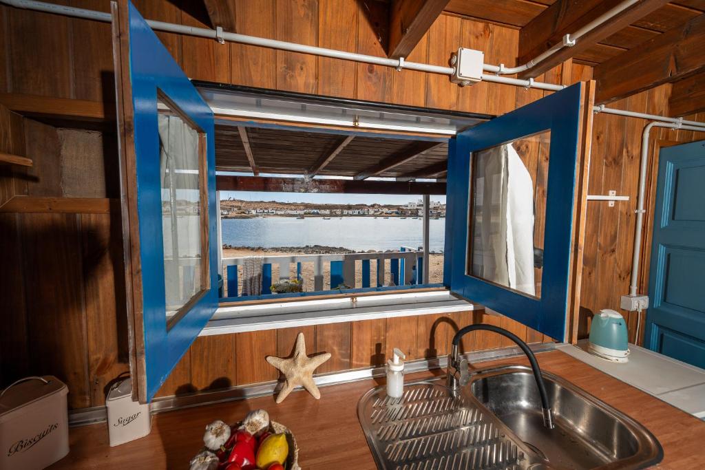 a kitchen with a sink and a window at Cabin in front of idyllic majanicho beach in Majanicho