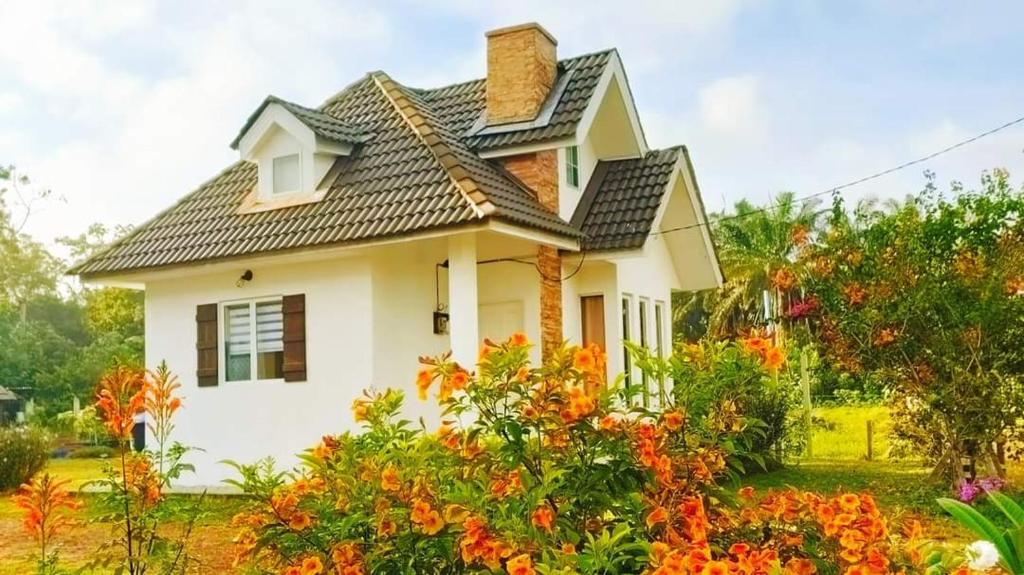 a house with orange flowers in front of it at Tehel Farmhouse in Melaka