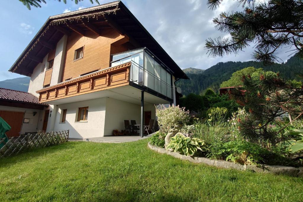 a house with a balcony on the side of it at Alpenglück Montafon in Sankt Gallenkirch
