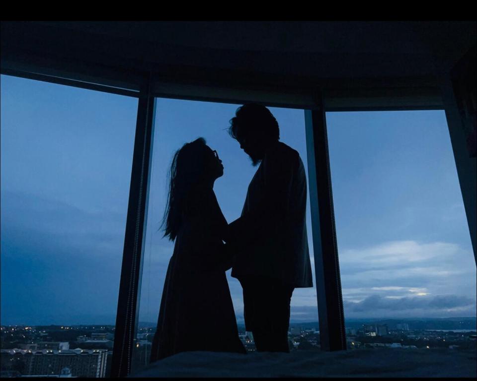 a man and a woman standing in front of a window at AEON Towers Davao in Davao City