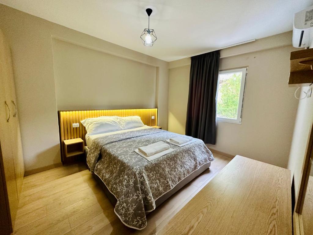 1 dormitorio con cama y ventana en CoastAL en Shëngjin