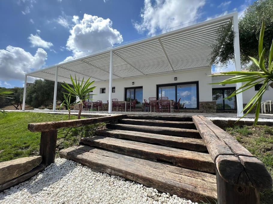 ein Haus mit Holztreppen vor einem Gebäude in der Unterkunft Villa - Finca Florida Benalup in Benalup Casas Viejas