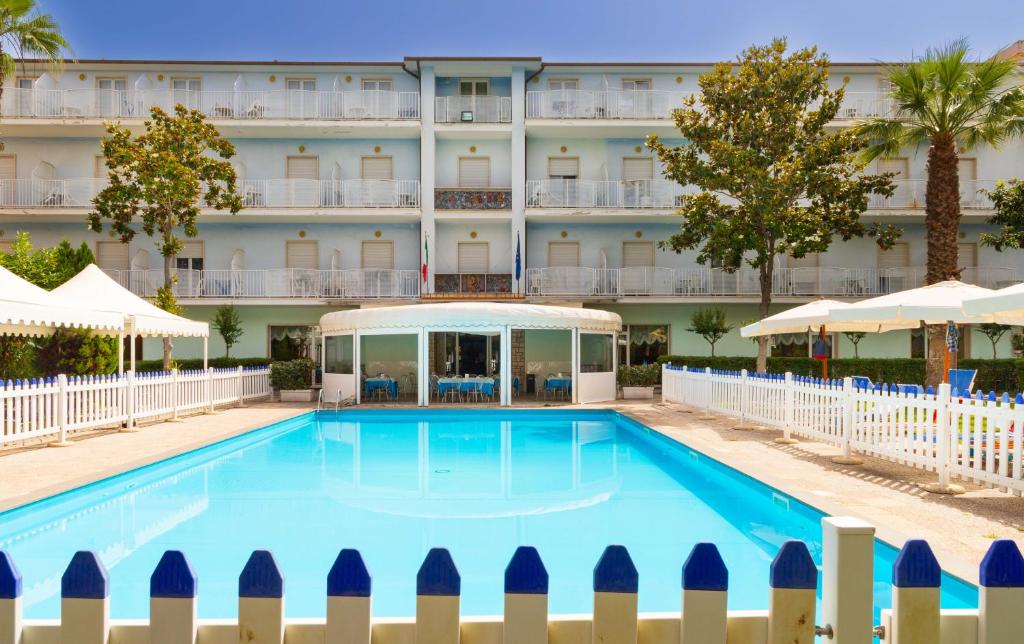 a swimming pool in front of a hotel at Centro Vacanze Domus M.G. in San Benedetto del Tronto