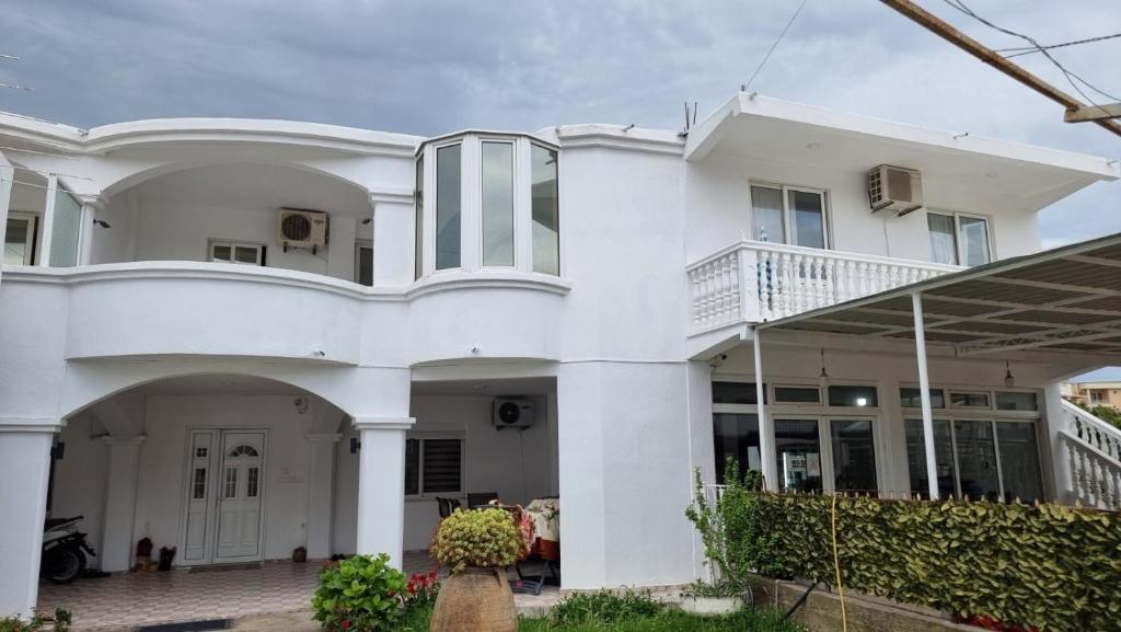 a white house with a balcony at Peci Apartments in Ulcinj