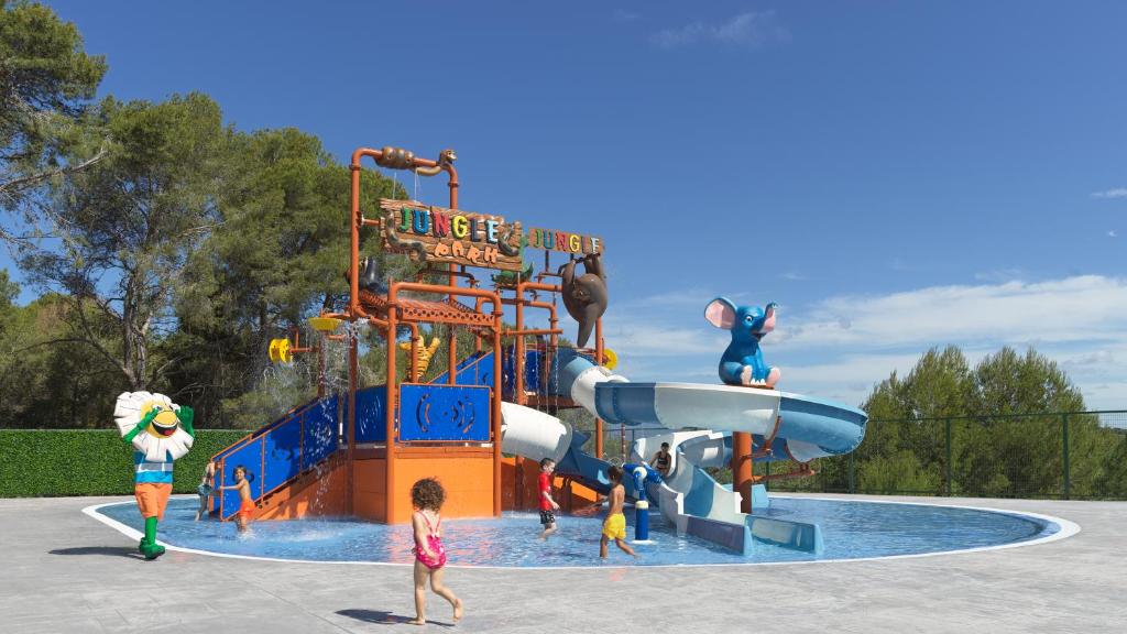 a group of children playing on a water slide at H10 Mediterranean Village in Salou