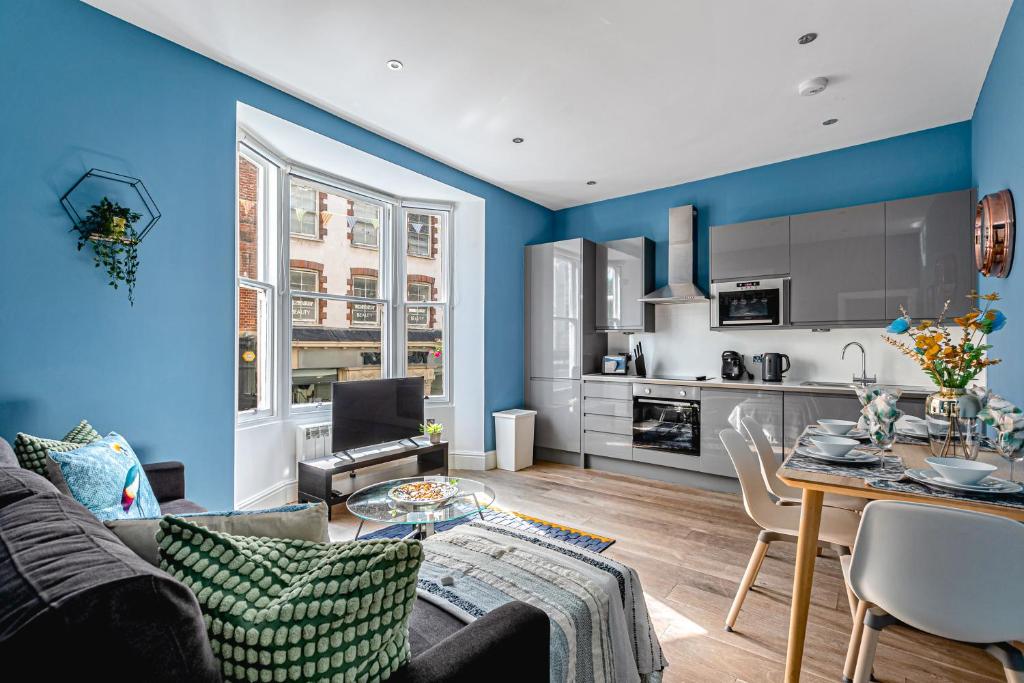 a living room with a couch and a dining room at Brighton Lanes by Airhost in Brighton & Hove