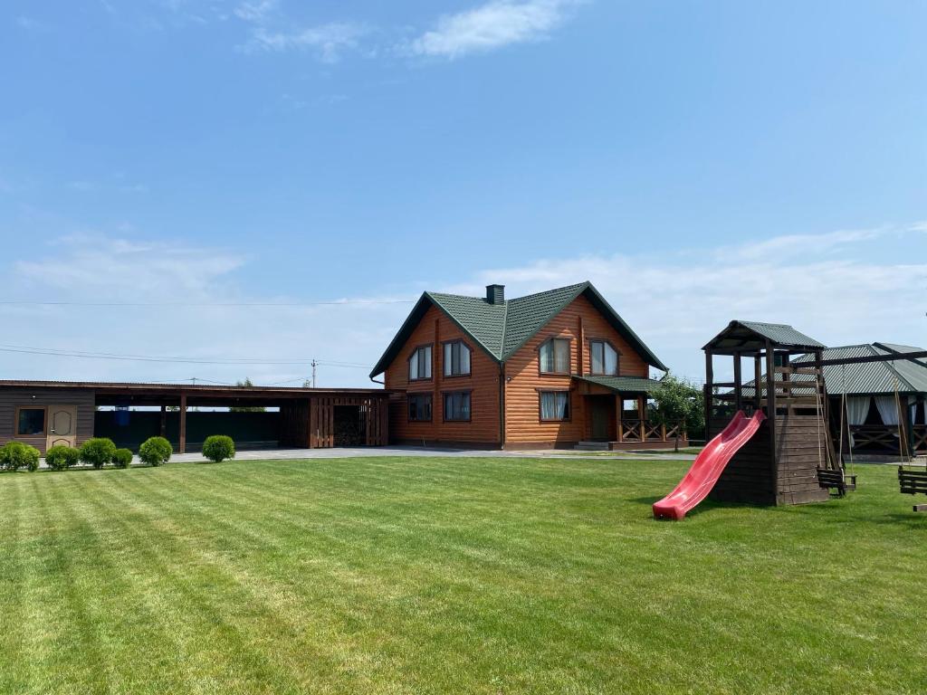 a house with a slide and a playground at Pulmo rest house in Pulʼmo