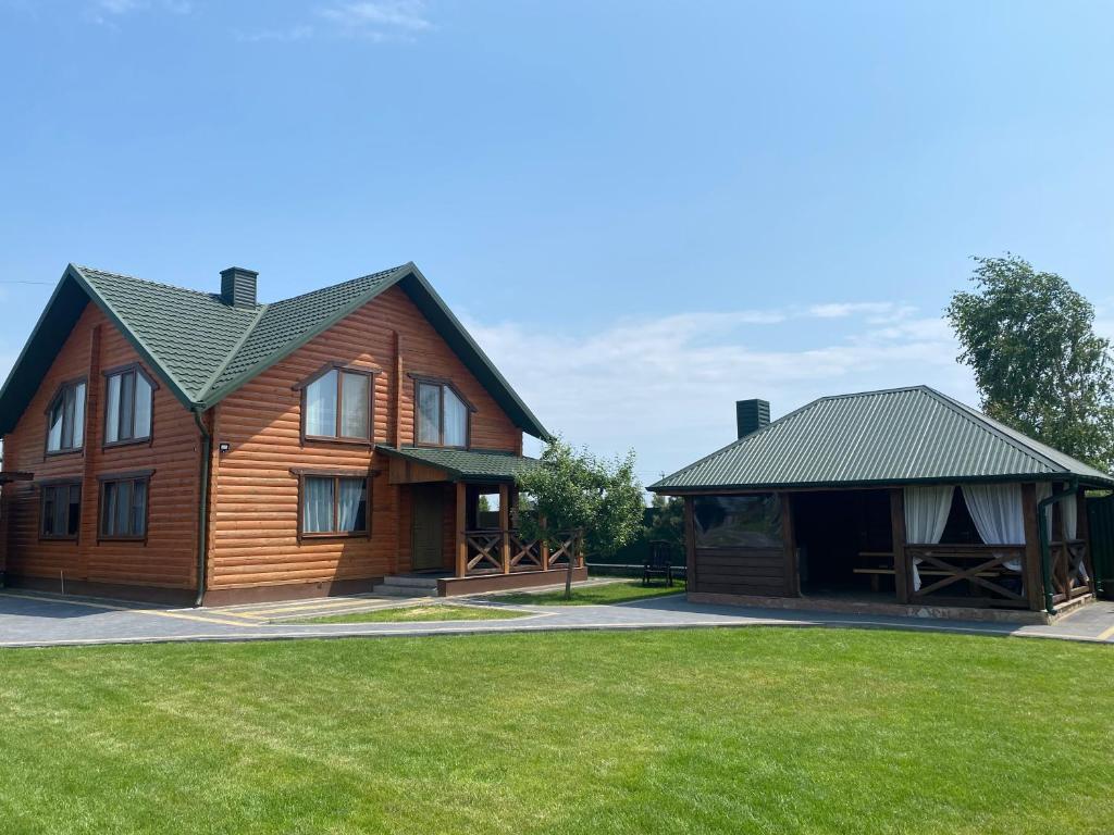 a large wooden house with a green lawn at Pulmo rest house in Pulʼmo