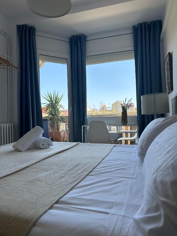 a bedroom with a large bed with a large window at Plaza Spain Barcelona Apartments in Barcelona