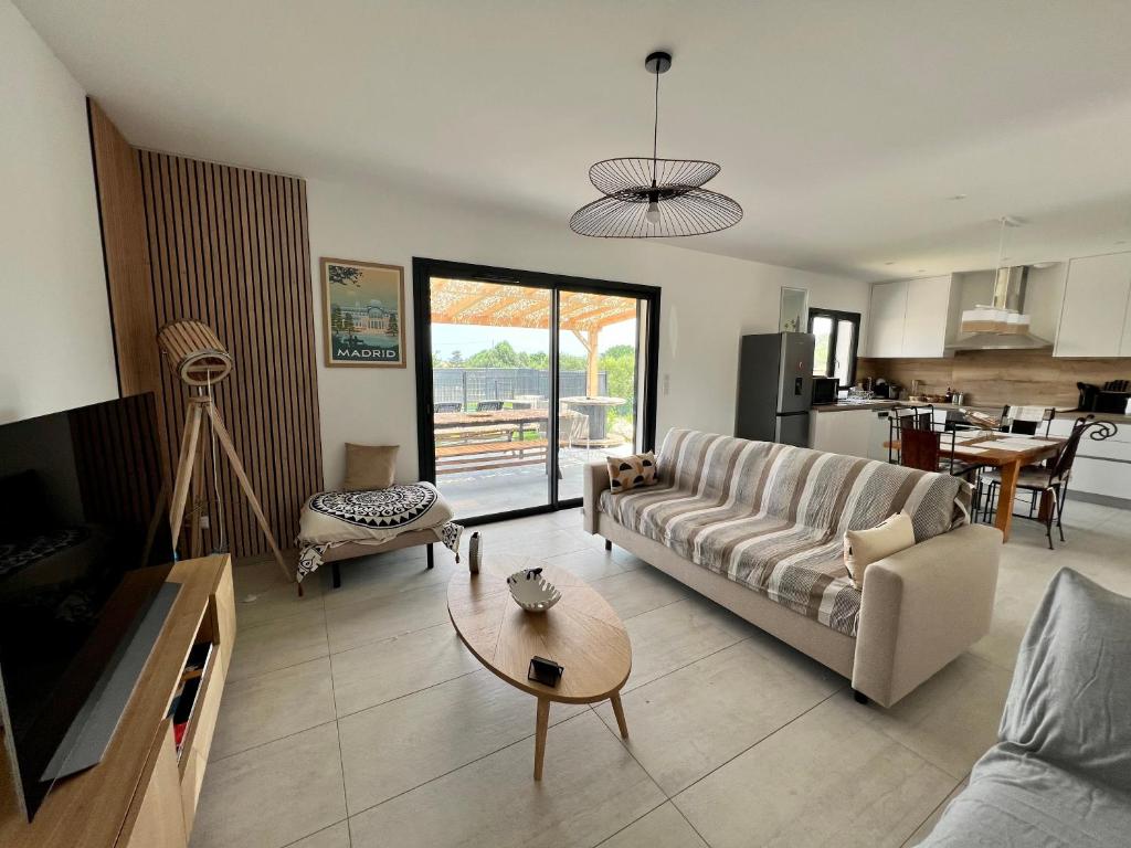 sala de estar con sofá y mesa en Casa Lamaghjone - Villa T4 avec piscine chauffée à 3,5km de la mer, en Aléria