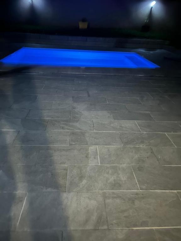 a blue light on a tile floor in a room at Villa Joly in Le Lamentin