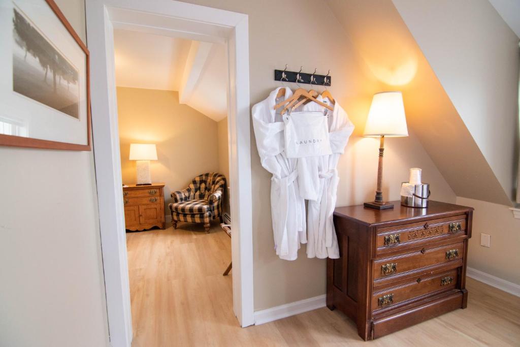 a room with a closet with a dresser and a mirror at The Beach House Inn in Kennebunk